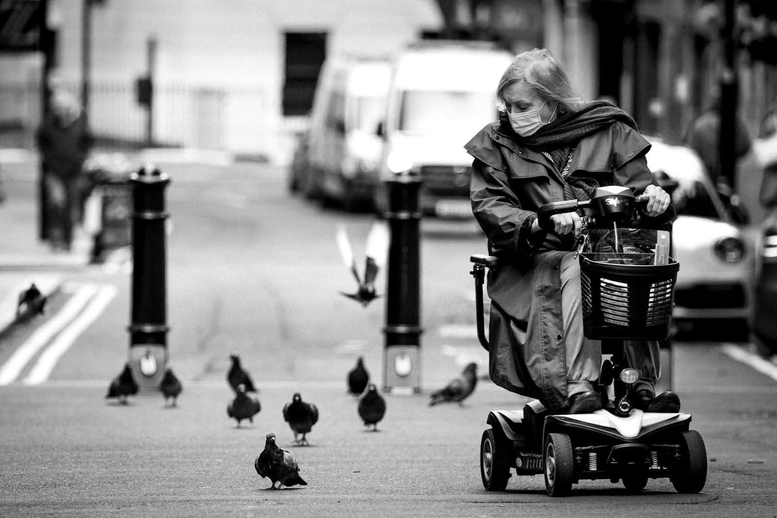 A senior riding  a mobility scooter